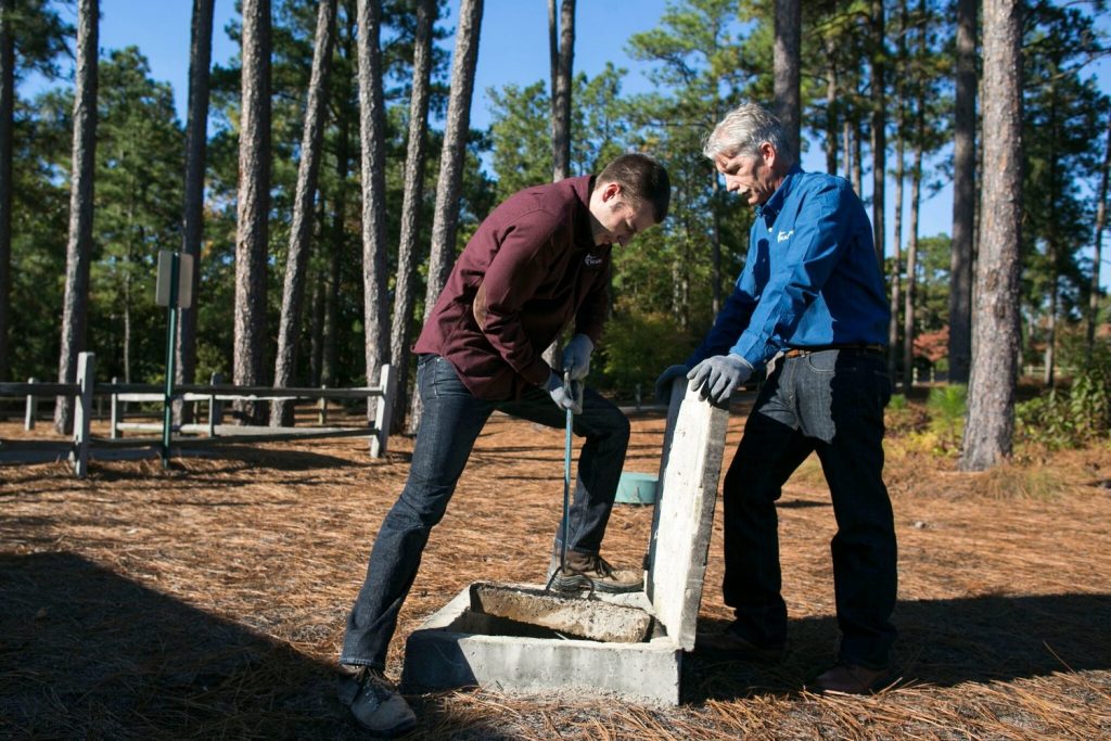 Image of homeowners cleaning their septic with a septic cleaner.