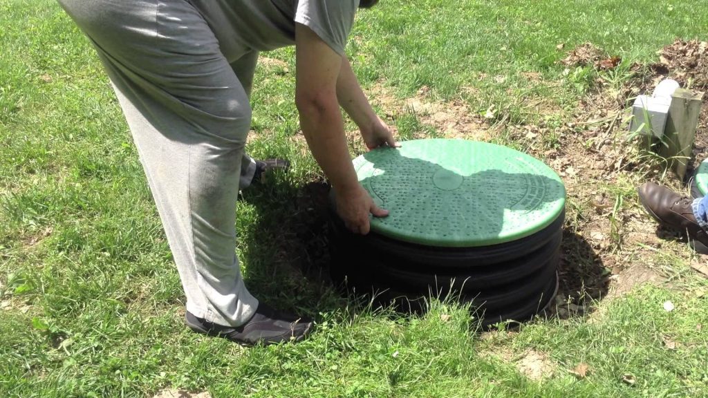 Image of a septic tank riser being installed.