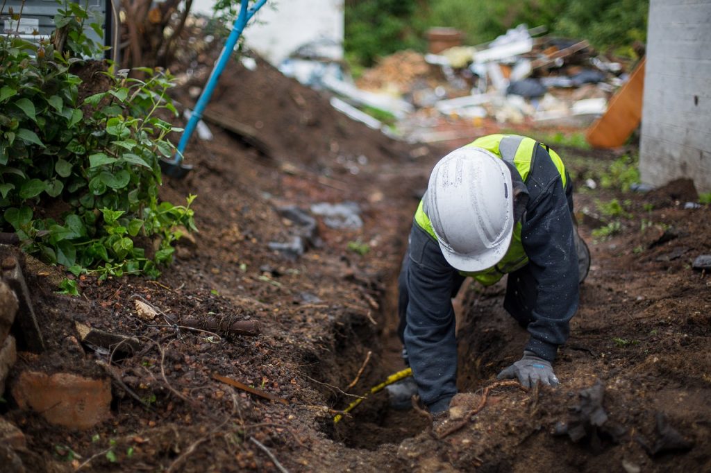 Image of a man who finds the property's cesspit.