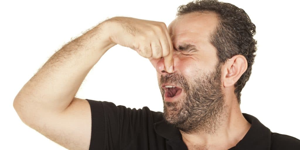 Image of a homeowner smelling his smelly raised mound.