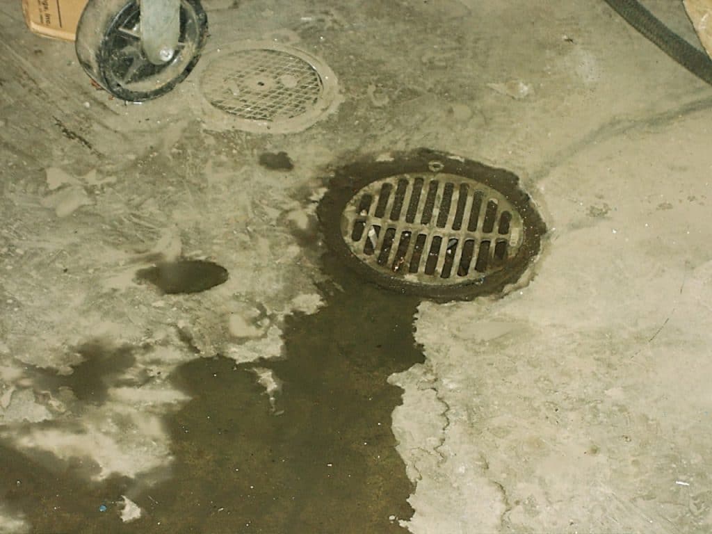 Image of a drain emitting septic fumes.