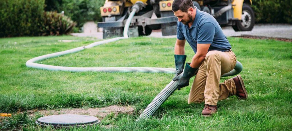 Image of man administering sand mound maintenance products.