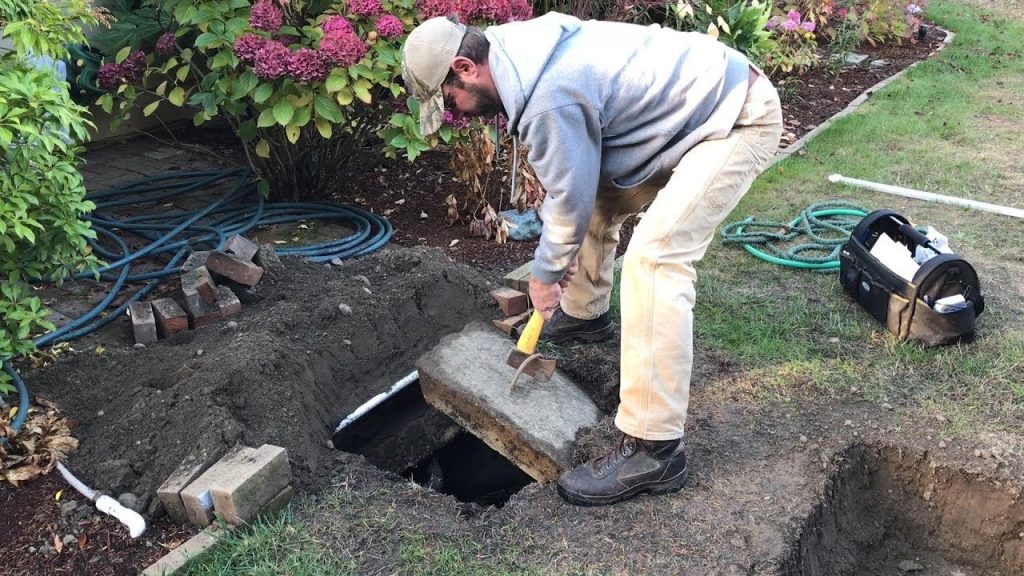 Image of a homeowner inspecting his cesspit.