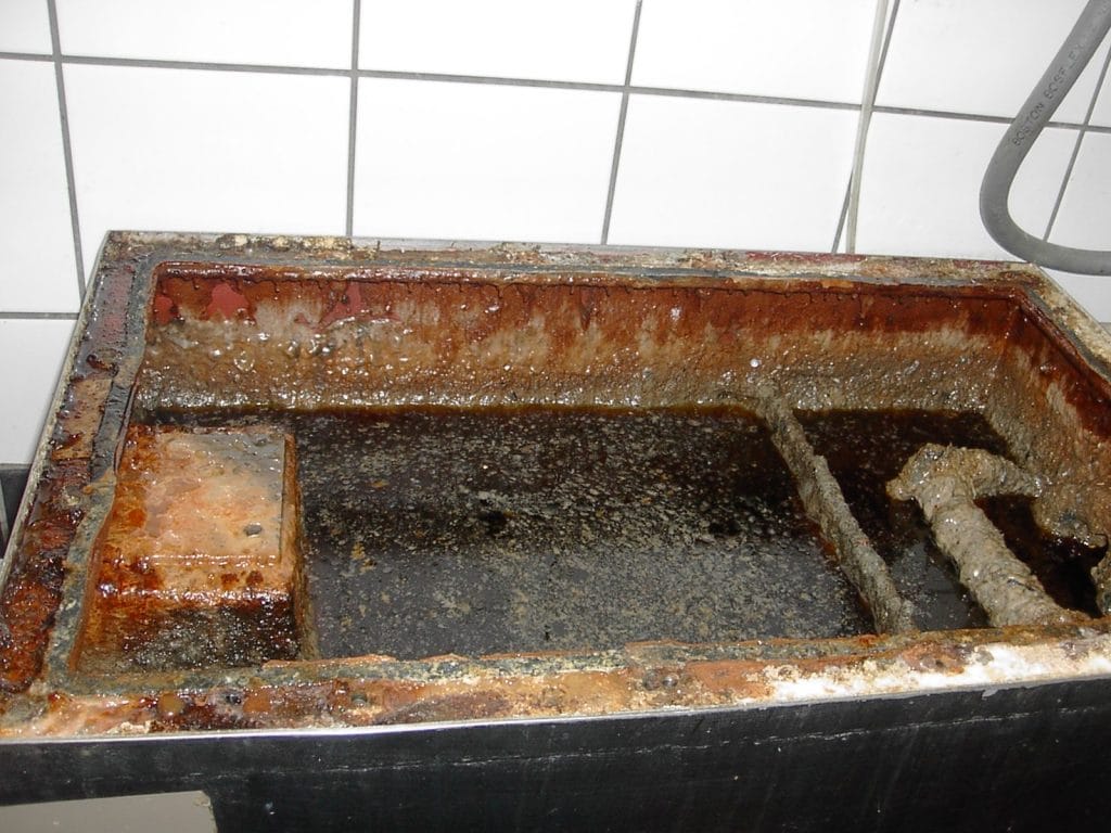 Image of commercial grease trap flooding.