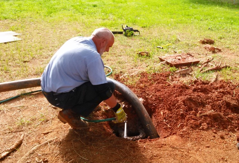 Image of a professional pumping a septic tank.